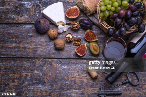 white wine in abottle, cork, bottle screw and a set of products - cheese, grapes, nuts, olives,... - cork material bildbanksfoton och bilder