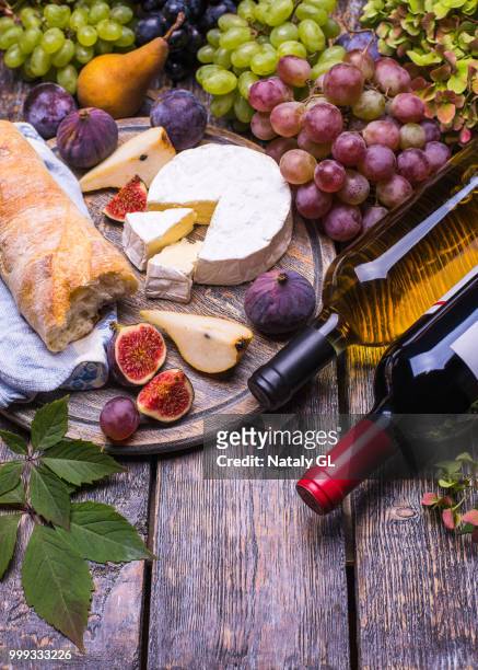 red wine in a bottle and in the glass, cork, bottle screw and a set of products - cheese, grapes,... - cork material bildbanksfoton och bilder