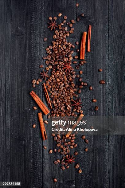 coffee beans and spices on the black wooden table - alina stock pictures, royalty-free photos & images