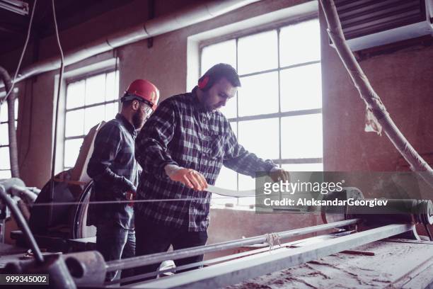 carpentry workers in factory sanding wooden chair parts - aleksandar georgiev stock pictures, royalty-free photos & images