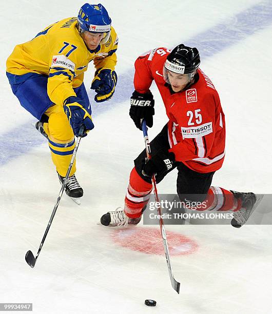 Sweden's Victor Hedman vies with Switzerland Thibaut Monnet during the IIHF Ice Hockey World Championship match Switzerland vs Sweden in the southern...