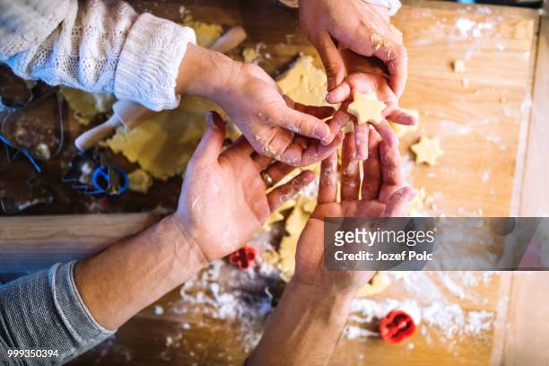 young family making cookies at home. - jozef polc stock pictures, royalty-free photos & images