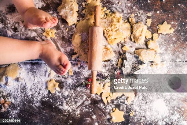 young family making gingerbread cookies at home. - jozef polc stock pictures, royalty-free photos & images