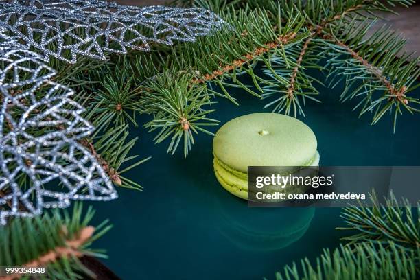 fresh green almond macaroon pastry on christmas table decorated with fir branches. copy space. - medvedeva ストックフォトと画像