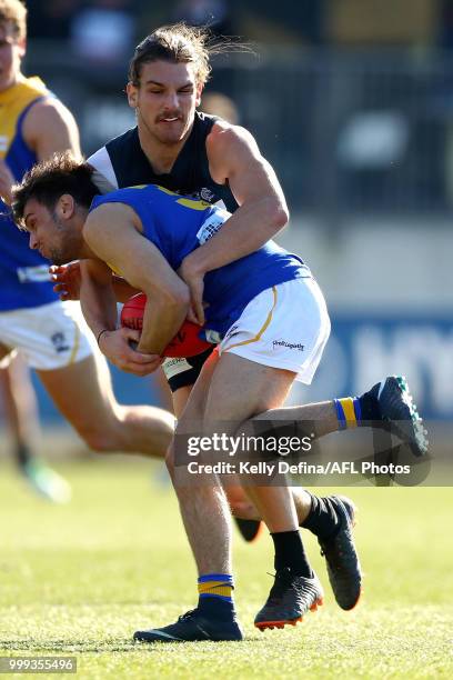 Brayden Monk of the Seagulls is tackled by Jesse Palmer of the Blues during the round 15 VFL match between the Northern Blues and Williamstown at...