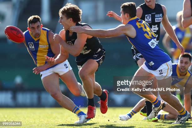 Samuel Fisher of the Blues handballs during the round 15 VFL match between the Northern Blues and Williamstown Seagulls at Ikon Park on July 15, 2018...