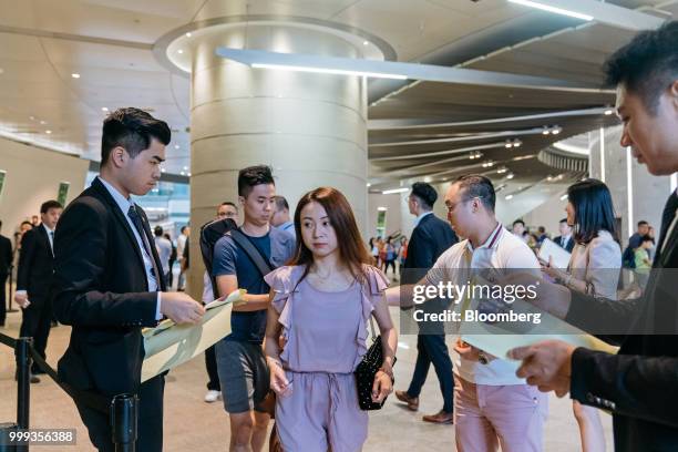 People arrive at the sales office for the Victoria Harbour residential project, developed by Sun Hung Kai Properties Ltd., in Hong Kong, China, on...