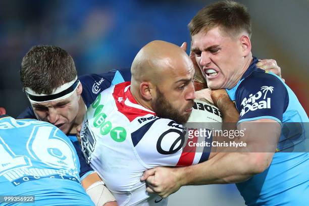 Blake Ferguson of the Roosters is tackled during the round 18 NRL match between the Gold Coast Titans and the Sydney Roosters at Cbus Super Stadium...