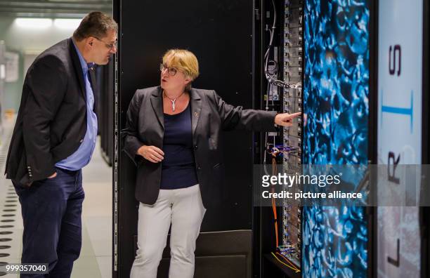 Theresia Bauer , Science Minister for the state of Baden-Wurttemberg being shown a part of the supercomputer "Hazel Hen" by Michael Resch , director...