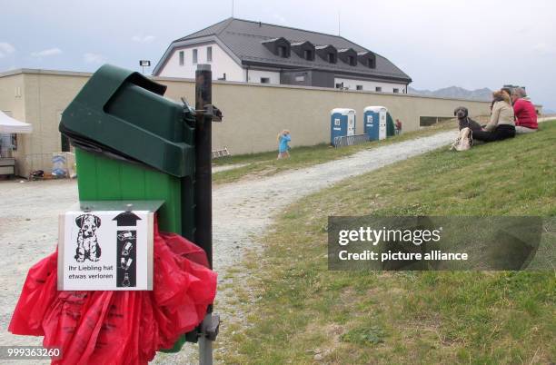 Picture of a dog toliet, bags for dog droppings and a trash can, taken in Muottas Muragl - a good 2500 meters high - in the canton of Graubunden,...