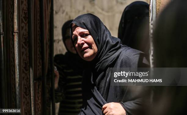 Relatives of 16-year-old Palestinian Louai Kaheel, who was killed during Israeli air strikes the day before, mourn during his funeral in Gaza City on...