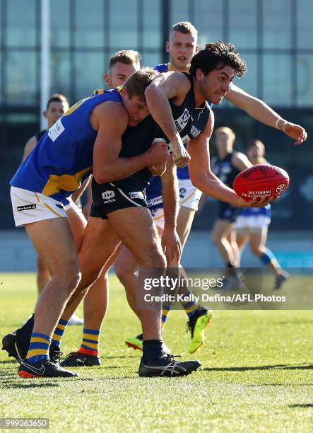 Marcus Stavrou of the Blues handballs during the round 15 VFL match between the Northern Blues and Williamstown Seagulls at Ikon Park on July 15,...