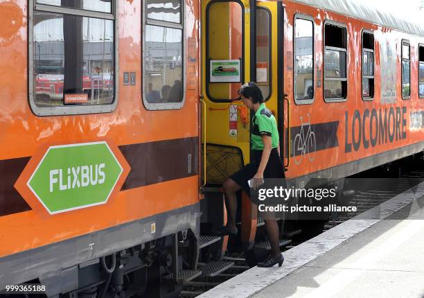 Woman enters the Locomore waggon during the recommissioning of the trainline between Berlin and Stuttgart at the train station Lichtenberg in Berlin,...