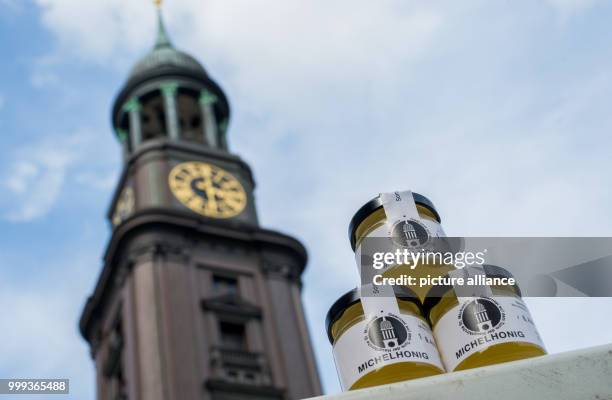 Three glasses of "Michaelhoney" are standing in front of the St. Michael's Church in Hamburg, Germany, 24 August 2017. St. Michael's follows the...