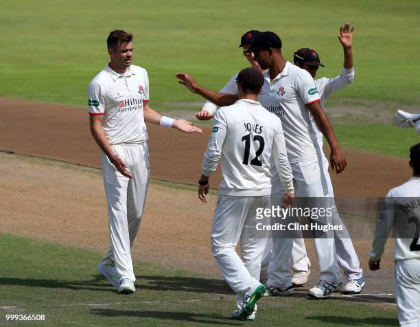 James Anderson of Lancashire celebrates with his team-mates after taking the wicket of Nottinghamshire's Joe Evison during the Lancashire Second XI v...