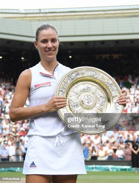 Angelique Kerber of Germany poses with The Venus Rosewater Dish after winning the Ladies Singles final against Serena Williams of The United States...