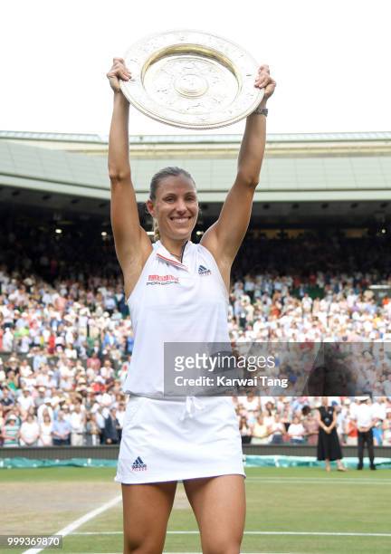 Angelique Kerber of Germany poses with The Venus Rosewater Dish after winning the Ladies Singles final against Serena Williams of The United States...
