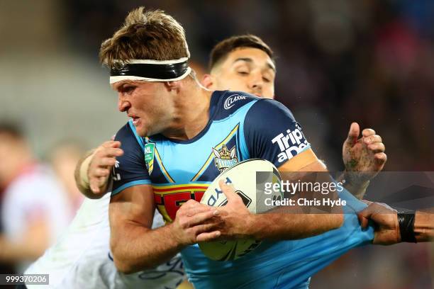 Mitch Rein of the Titans is tackled during the round 18 NRL match between the Gold Coast Titans and the Sydney Roosters at Cbus Super Stadium on July...
