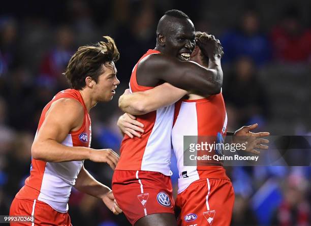 Aliir Aliir of the Swans is congratulated by team mates after kicking the winning goal during the round 17 AFL match between the North Melbourne...
