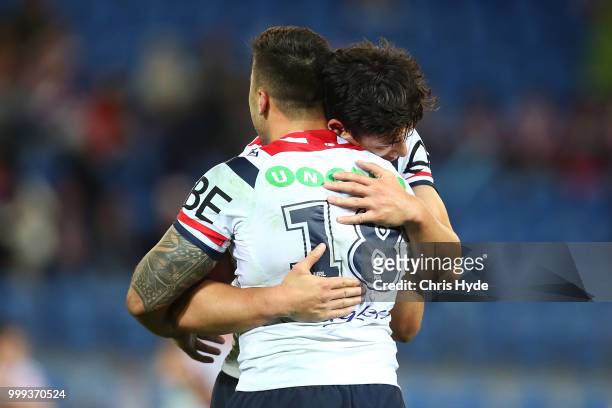 Matthew Ikuvalu and Joseph Manu of the Roosters celebrate winning the round 18 NRL match between the Gold Coast Titans and the Sydney Roosters at...