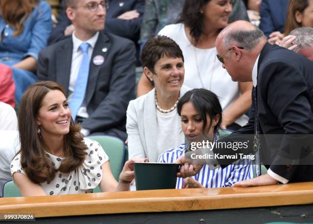 Catherine, Duchess of Cambridge and Meghan, Duchess of Sussex attend day twelve of the Wimbledon Tennis Championships at the All England Lawn Tennis...