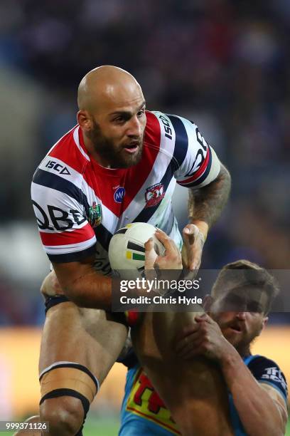 Blake Ferguson of the Roosters is tackled during the round 18 NRL match between the Gold Coast Titans and the Sydney Roosters at Cbus Super Stadium...