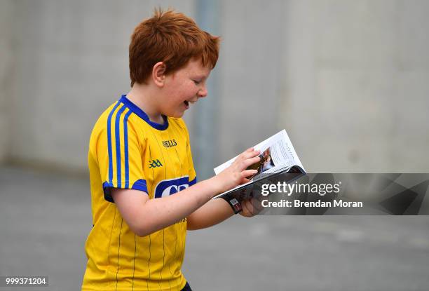 Laois , Ireland - 7 July 2018; A young fan checks out his match programmes prior to the GAA Football All-Ireland Senior Championship Round 4 match...
