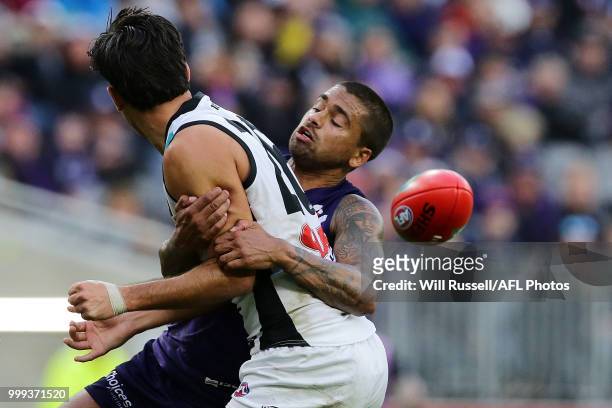 Riley Bonner of the Power is tackled by Bradley Hill of the Dockers during the round 17 AFL match between the Fremantle Dockers and the Port Adelaide...