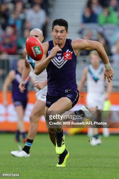 Bailey Banfield of the Dockers chases the ball during the round 17 AFL match between the Fremantle Dockers and the Port Adelaide Power at Optus...