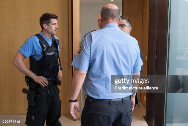 Police officers standing in front of a hall where the NSU Investigative Committee is meeting in the Landtag in Wiesbaden, Germany, 25 August 2017....