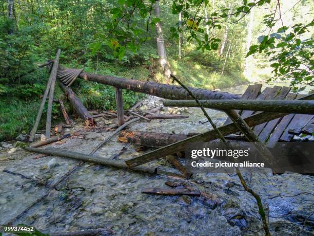 Collapsed pedestrian bridge lying on the Weissbach river near Schneizlreuth, Germany, 25 August 2017. After the wooden bridge collapsed on 24 August...