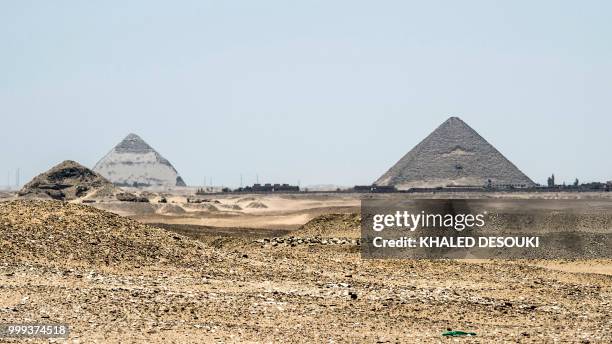 Picture taken on July 14, 2018 shows a view of the Dahshur pyramids from the Saqqara necropolis, about 35 kms south of the Egyptian capital Cairo,...