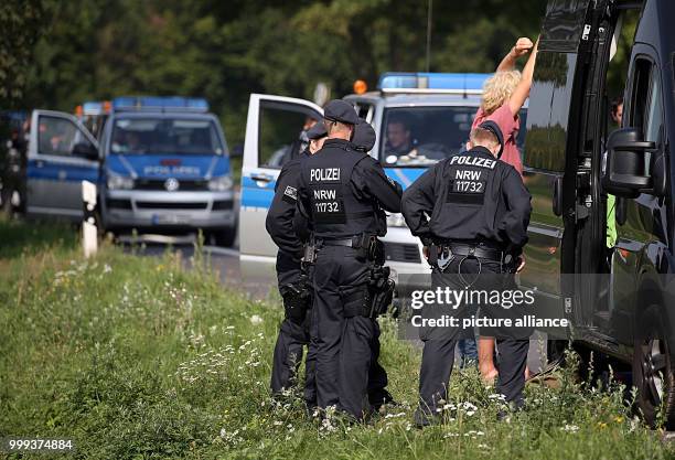 Dpatop - Police officers searching a person in front of the Climate Camp near Erkelenz, Germany, 25 August 2017. Environment activists are attempting...