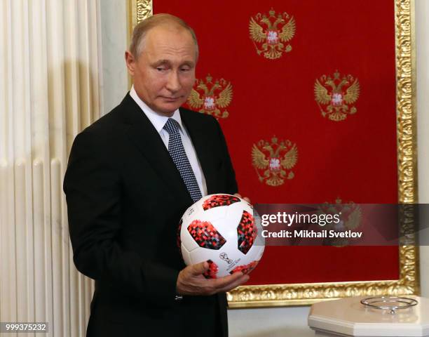 Russian President Vladimir Putin passes symbolic FIFA World Cup Baton to Qatari Emir Tamim bin Hamad al-Thani during the ceremony at the Kremlin, in...