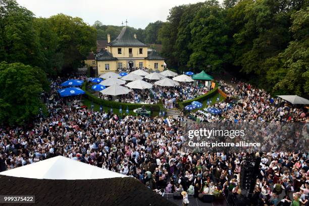 July 2018, Germany, Munich: People dancing at the Kocherlball by the Chinesischer Turm . Every year, thousands of people gather in the early morning...