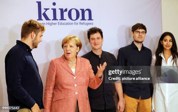 German Chancellor Angela Merkel visiting the Berlin start-up Kiron and being briefed on the company's work by employees Vincent Zimmer , Markus...
