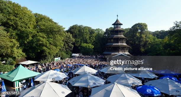 July 2018, Germany, Munich: People dancing at the Kocherlball by the Chinesischer Turm . Every year, thousands of people gather in the early morning...