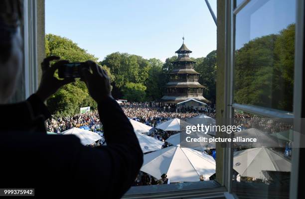 July 2018, Germany, Munich: People dancing at the Kocherlball by the Chinesischer Turm . Every year, thousands of people gather in the early morning...