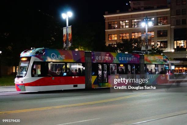 streetcar on a dark city street, detroit, michigan, usa - detroit city stock pictures, royalty-free photos & images