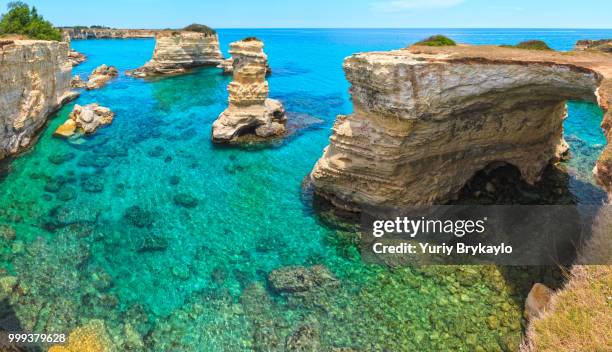 faraglioni at torre sant andrea, italy - sant�� stock-fotos und bilder