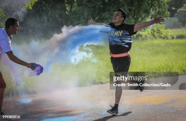 Army National Guard Soldier spreading hands while crossing the finish line at the 2018 New Jersey National Guard LGBT Color Run, Joint Base...