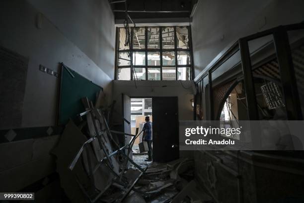 Palestinian man inspects damage at the building of Ministry of Awqaf and Religious Affairs of Palestine after Israeli fighter jets pounded Al Katiba...