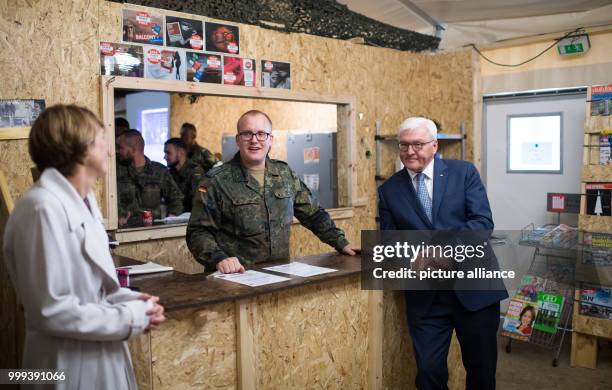 Dpatop - German President Frank-Walter Steinmeier and his wife Elke Buedenbender speaking with German soldiers during a visit to the German-led NATO...