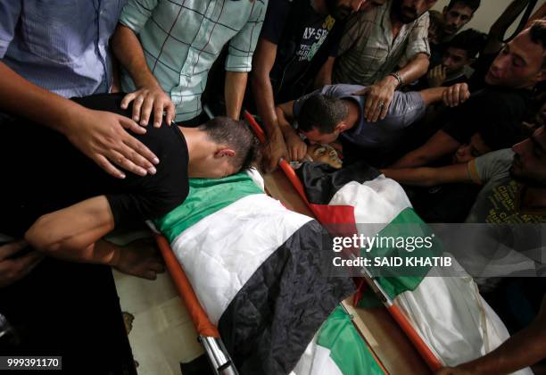 Graphic content / Relatives and mourners bid farewell to the bodies of Palestinian teenagers Amir Al-Namira and Louai Kaheel during their funeral at...