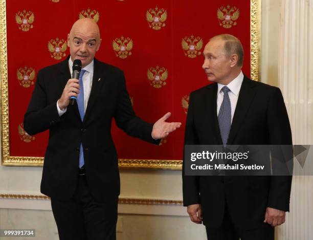 Russian President Vladimir Putin looks on FIFA President Gianni Infantino during the ceremony at the Kremlin, in Moscow, Russia, July 2018. Qatar is...