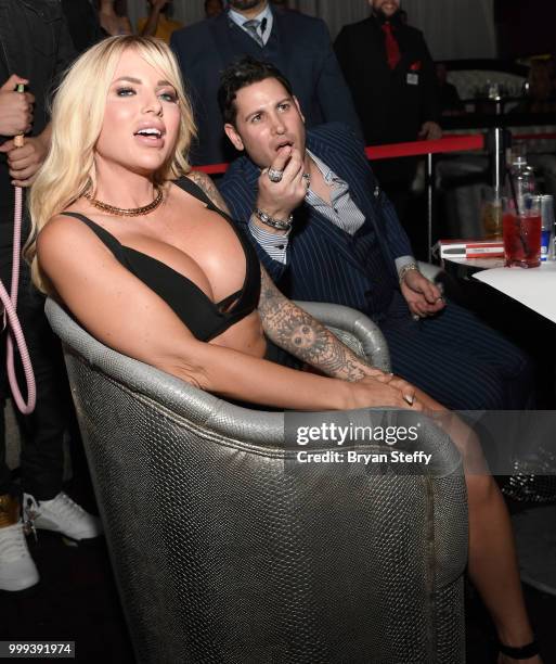 Model Jessica Weaver and producer Dave Bryant react during "Foxy Boxing" as she hosts Larry Flynt's Hustler Club Instagram party at Larry Flynt's...