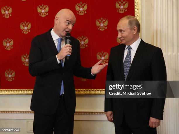 Russian President Vladimir Putin looks on FIFA President Gianni Infantino during the ceremony at the Kremlin, in Moscow, Russia, July 2018. Qatar is...