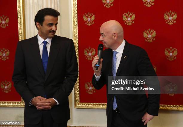 Qatari Emir Tamim bin Hamad al-Thani looks on FIFA President Gianni Infantino during the ceremony at the Kremlin, in Moscow, Russia, July 2018. Qatar...
