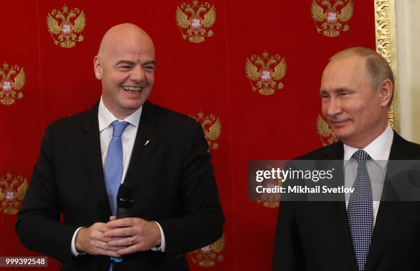 Russian President Vladimir Putin and FIFA President Gianni Infantino smile during the ceremony at the Kremlin, in Moscow, Russia, July 2018. Qatar is...