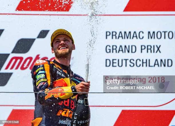 South African Red Bull KTM rider Brad Binder celebrates on the podium after winning the Moto2 race at the Grand Prix of Germany at the Sachsenring...